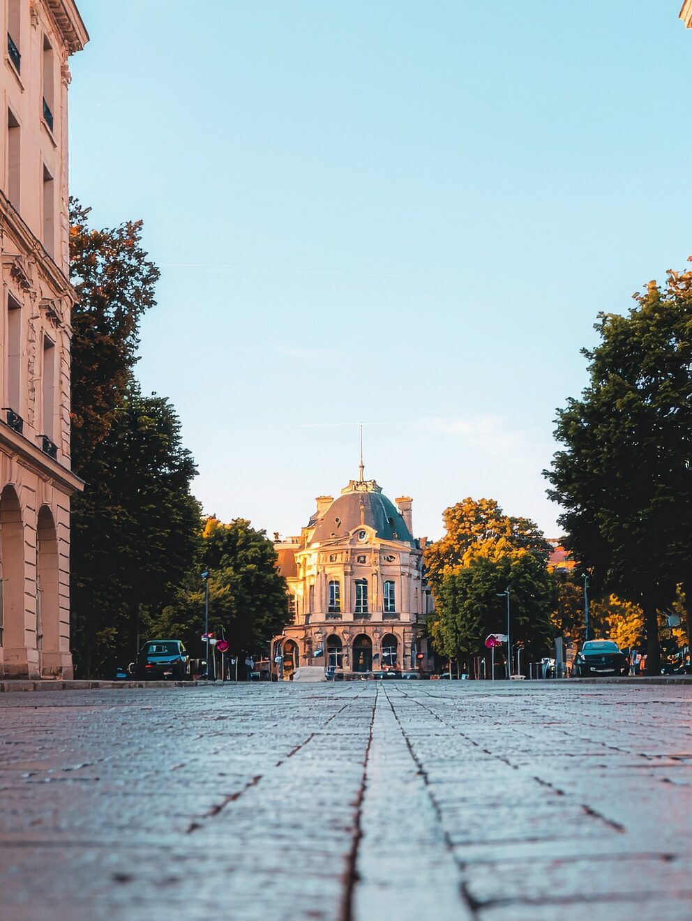 firefly a cinematic vertical image (9 16) showing a warm sunset cityscape inspired by france. 341199