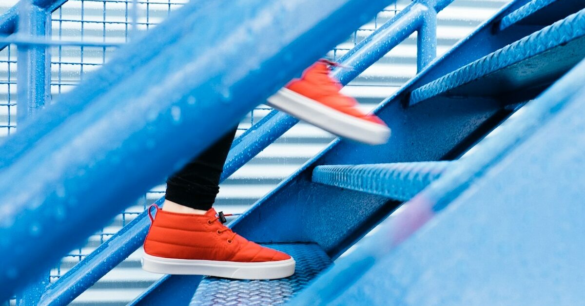 person stepping on blue stairs